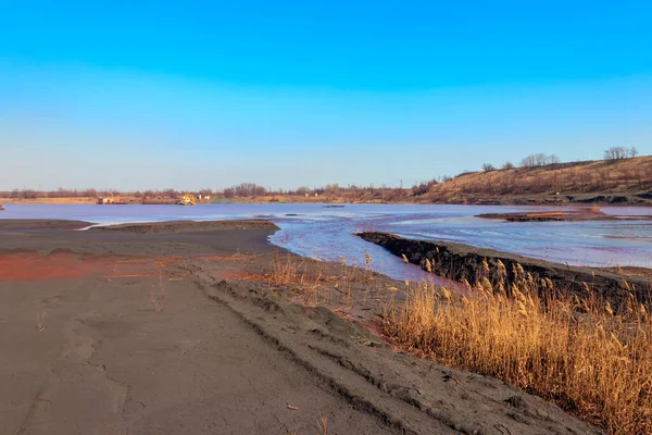 Technical settler of industrial water of mining industry in Kryvyi Rih, Ukraine. Red water polluted with iron ore waste