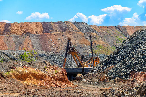 Big excavator working in iron ore quarry. Mining industry