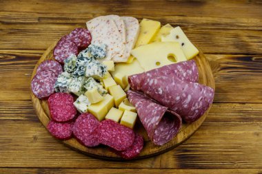 Tahta masada İtalyan salam ve peynirinden oluşan antipasti tabağı.