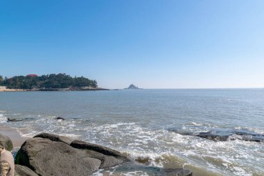 Deniz kenarında her türlü resif var, mavi gökyüzü ve deniz suyu.