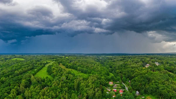 Aerial view of dark cloudy sky over forest minute before rain