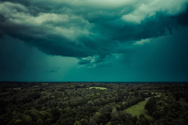 Aerial view of dark cloudy sky over forest minute before rain