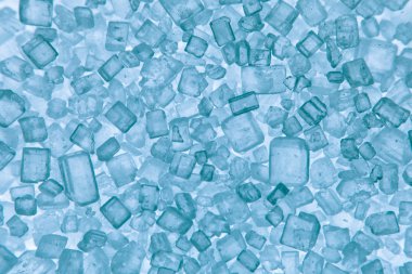 Macro sugar crystals blue colored clipart