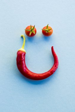 Kiraz tomates ve kırmızı sıcak biber biber gülen yüz şekillendirme