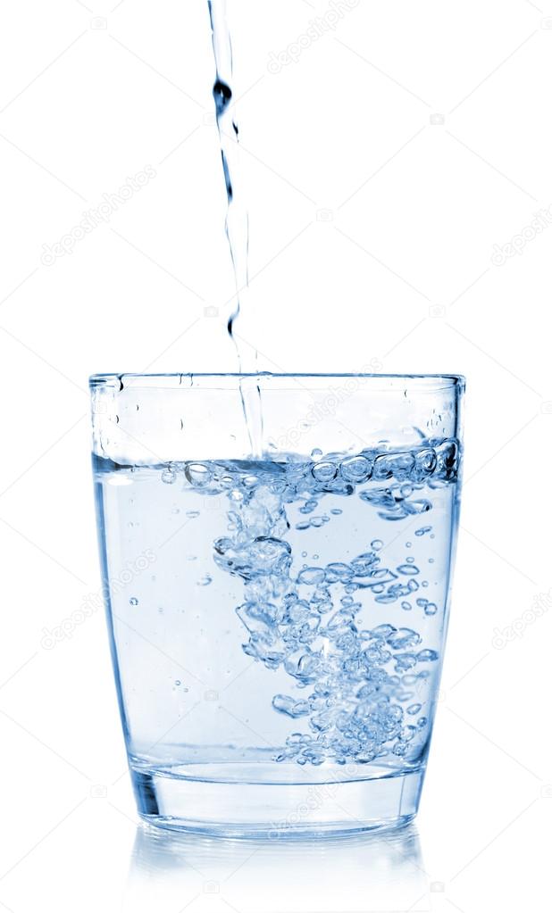 pouring water on a glass on white background.