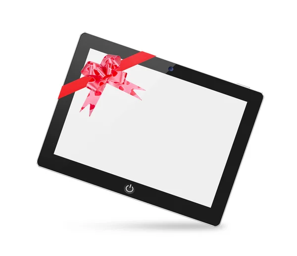 Gerçekçi tablet pc bilgisayar hediye olarak bir kırmızı yay ile boş ekran ile. — Stok fotoğraf