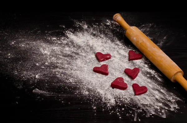 Red heart-shaped cookies on a flour, baking the day of Valentine's Day — 스톡 사진