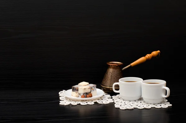 Rahat lokum and two cups of coffee on white napkins, pots on a black background. Space for text — Stock Photo, Image