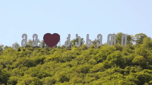 Duże litery gruziński na wzgórzu wśród zieleni kocham Kakheti — Wideo stockowe