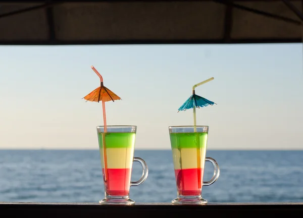 Dois coquetéis tricolores no balcão do bar em uma vista mar — Fotografia de Stock