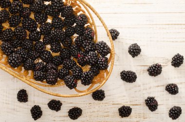 Tam sepet böğürtlen, çilek üzerinde masa lambası