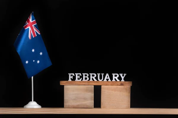Wooden calendar of February with Australian flag on black background. Holidays of Australia in February.