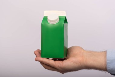 Beyaz arka planda yeşil kese kağıdı var. Meyve suyu yoğurt paketi. maket yap.