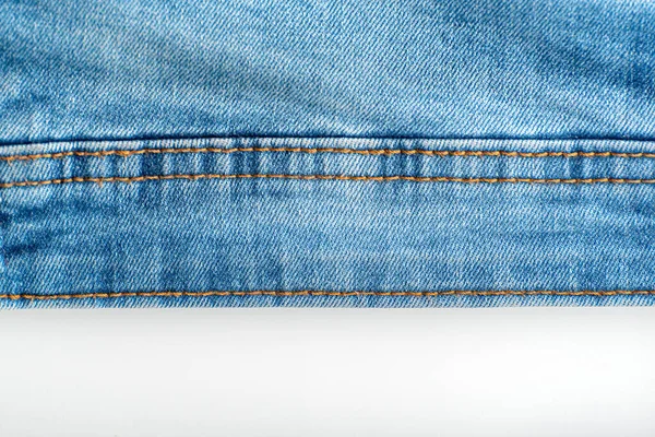 Stitching on jeans. Denim blue. Seam on fabric.