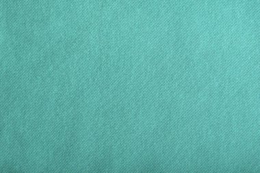 Yeşil homojen pamuk arka plan. Tekstil yüzeyi. Kumaş