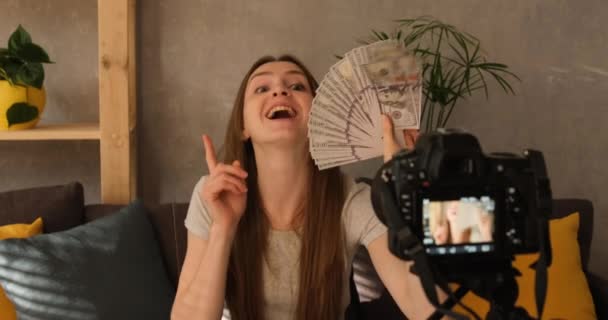 Vlogger spela in youtube video om ekonomi, resultat, investeringar. Ung kvinnlig bloggare spelar in video om pengar. — Stockvideo
