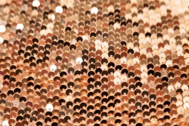 Golden shiny background. Fabric with gold sequins. Textile. Close up