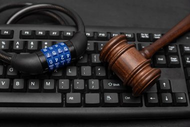 Gavel with combination lock on computer keyboard. Data Protection Concept
