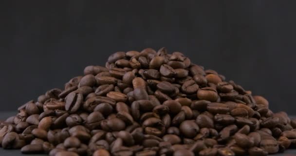 Pile of coffee roasted arabica coffee beans. Dark Coffee Grains. Top view. Rotating video. Loop motion. — Stock Video