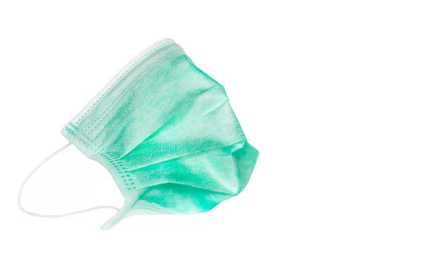 白い背景に隔離された緑の医療用マスク Covid 19保護背景コンセプト — ストック写真