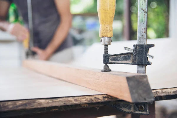 Carpenter Doing Wood Work Using Clamping Hand Tool — Stock Photo, Image