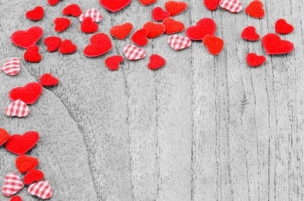 Small red hearts putting on monochrome wooden background — Stock Photo, Image