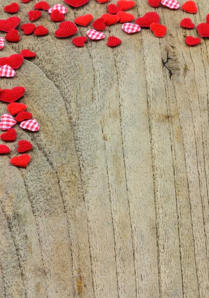 Kleine rote Herzen auf hölzernem Hintergrund — Stockfoto