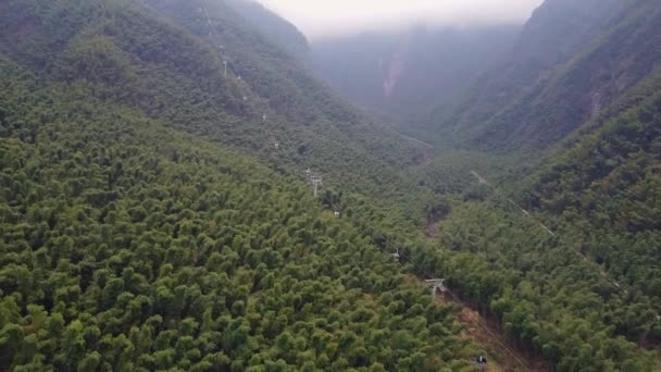 上から雲 アジア 中国の山々 江西省 Yichun ビューで覆われている上にゆっくりと移動ロープウェイでMingyue山の緑の谷 — ストック動画