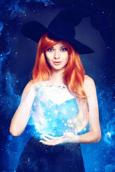 Beautiful young woman as halloween witch — Stock Photo, Image