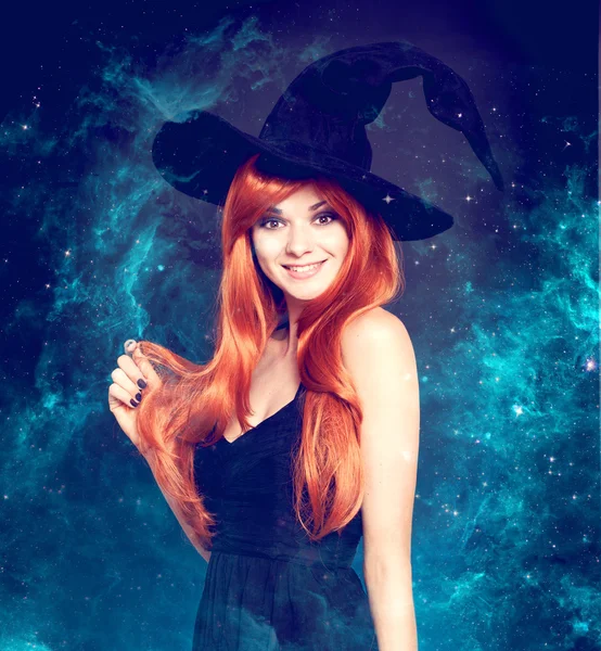 Beautiful young woman as halloween witch — Stock Photo, Image