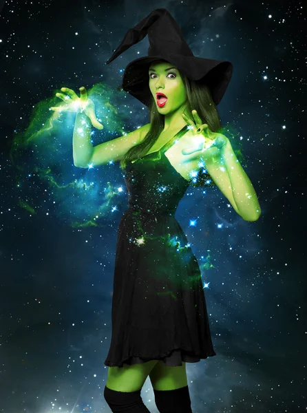Beautiful young woman as halloween witch — Stock Photo, Image