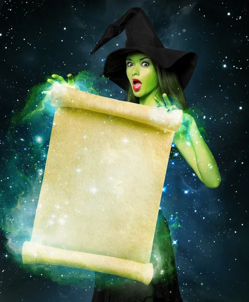 Beautiful young woman as halloween witch — Stock Photo, Image