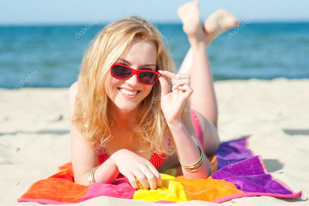 Beautiful young woman on a beach - summer portrait