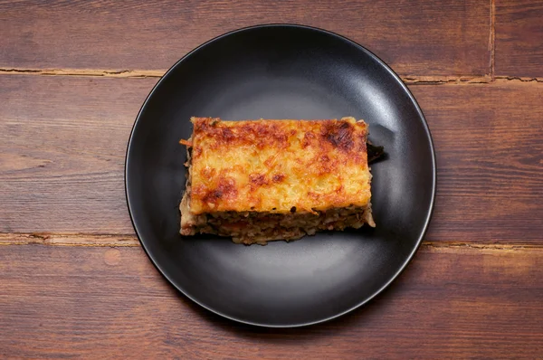 Piece of lasagna in the center — Stock Photo, Image