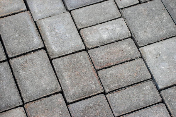 A fragment of the texture of the layout of street tiles of different sizes for the drawing