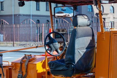 Steering wheel and a fragment of the cab of an asphalt skating rink