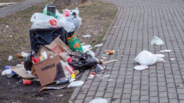 Scattered trash past the trash can