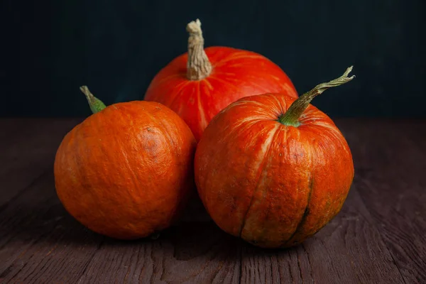 Pumpkins on wooden table in dark mood. — Stock Photo, Image