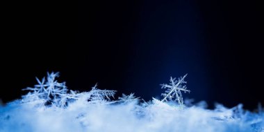 Siyah arkaplanda beyaz kristal kar taneleri