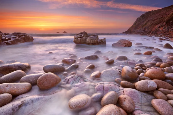 Rocky beach at sunset, Porth Nanven, Cornwall, England — Stock Photo, Image