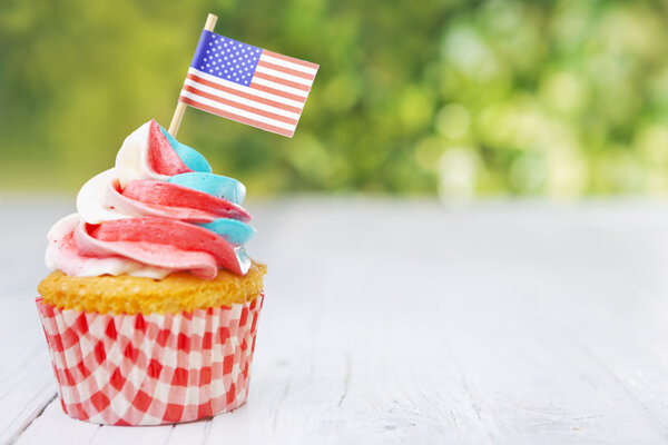 Cupcake with red-white-and-blue frosting and American flags