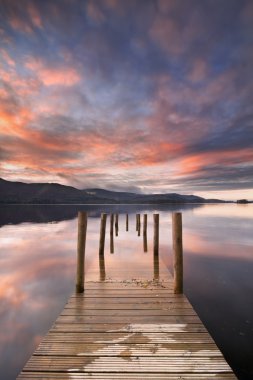 Flooded jetty in Derwent Water, Lake District, England at sunset clipart