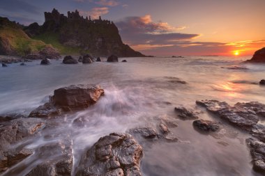 The Dunluce Castle in Northern Ireland at sunset clipart