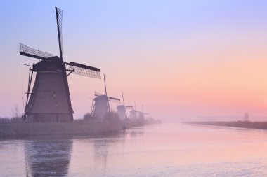 Traditional Dutch windmills at sunrise in winter at the Kinderdi clipart
