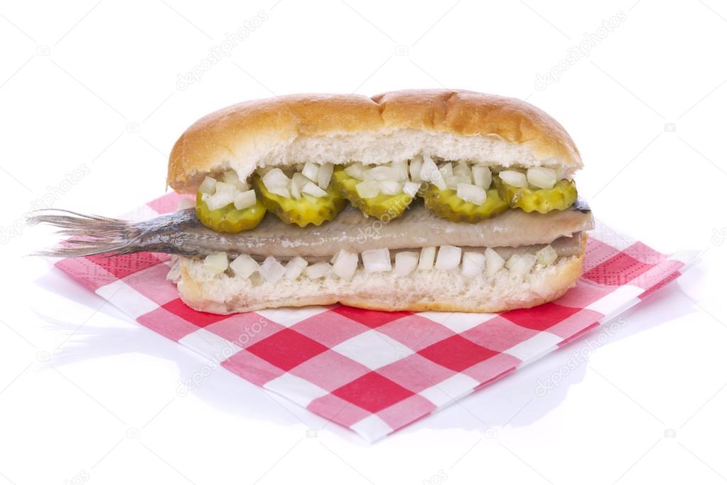Sandwich with herring ('haring'), onions and pickles, isolated o