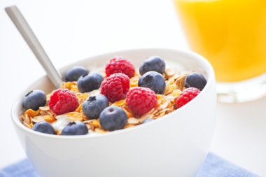 Healthy breakfast with muesli, fresh fruit and orange juice