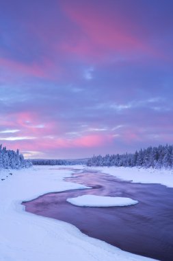 Sunrise over river rapids in a winter landscape, Finnish Lapland clipart