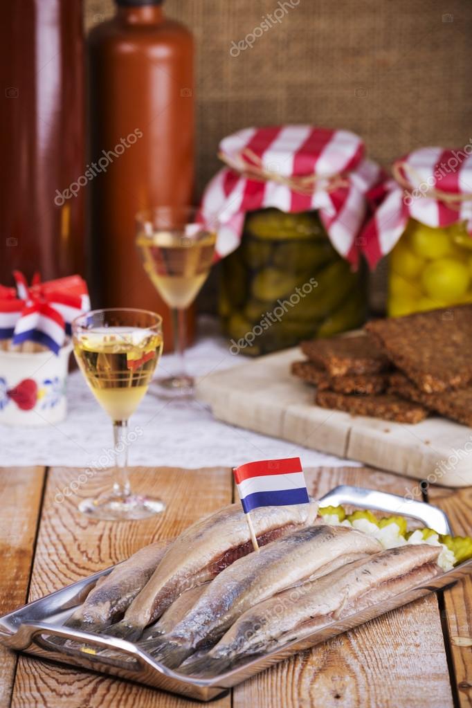 Dutch herring ('haring') with onions and pickles on rustic table Stock Photo by ©sara_winter