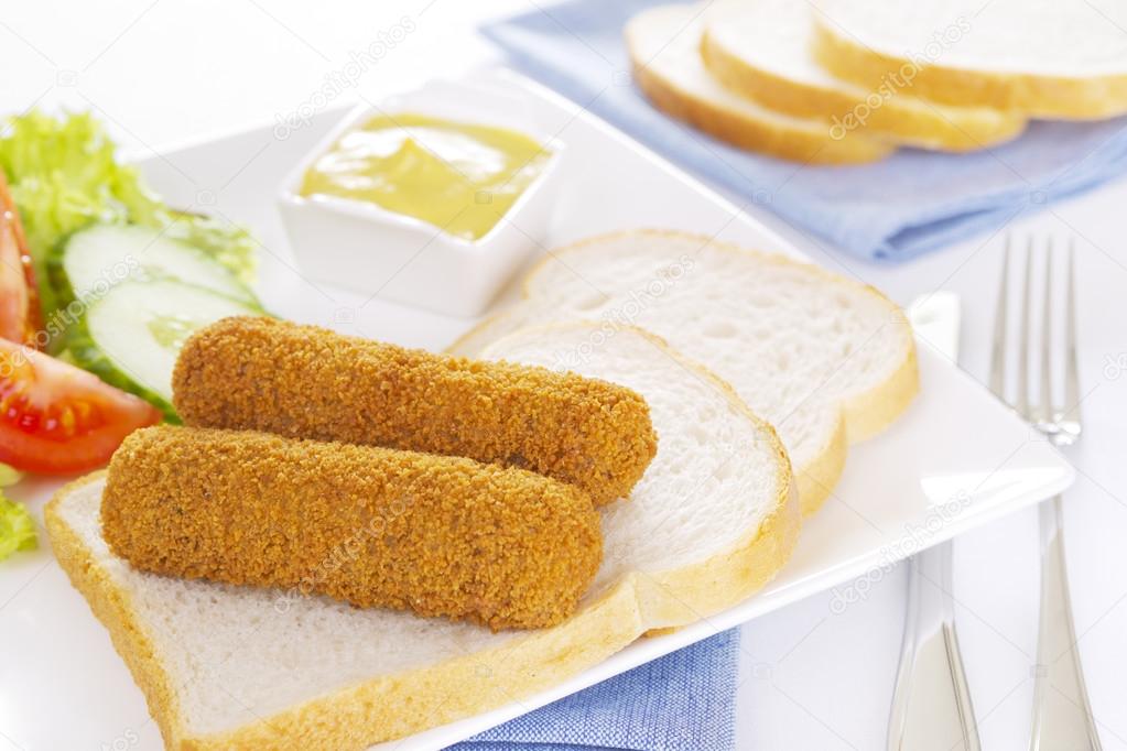 Dutch meat croquettes ('kroket') and bread on a plate