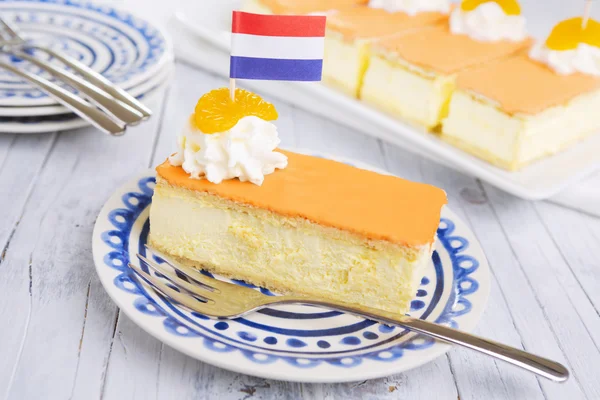 Oranje tompouce, traditionele Nederlandse gebak, op een rustieke tafel — Stockfoto